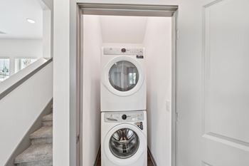 A white washing machine and dryer in a small laundry room.